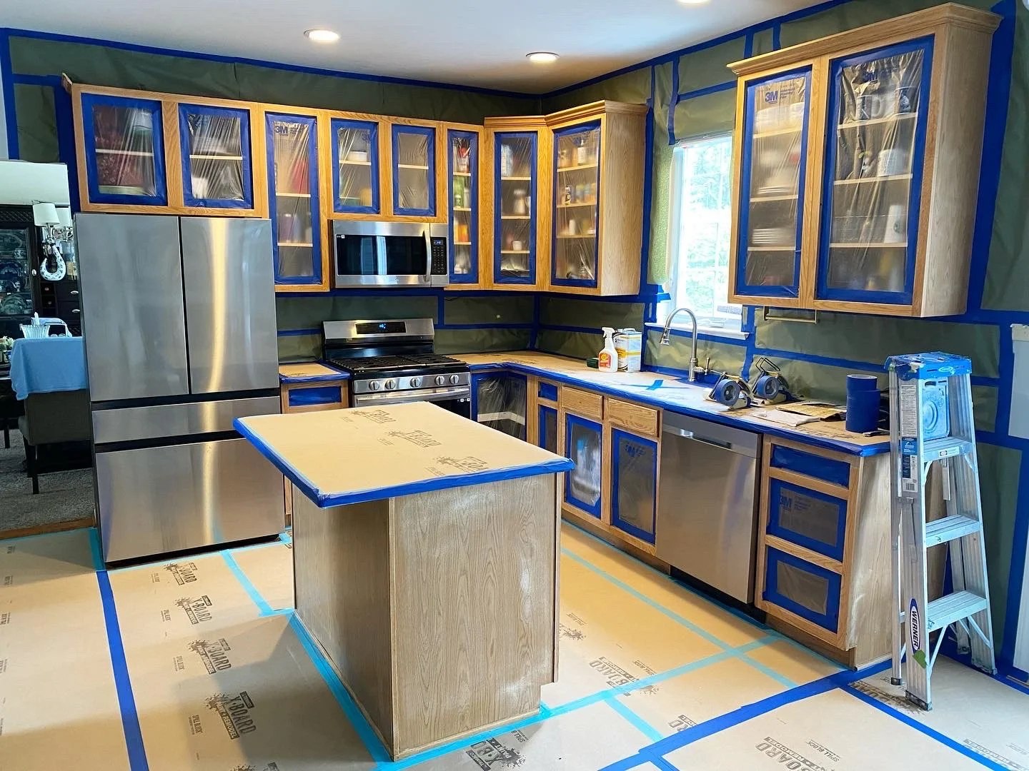 Kitchen cabinets carefully masked and prepped for cabinet painting